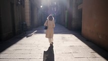 Woman walking alone in Barcelona Gothic Quarter. Facades of medieval apartment buildings, narrow street of Europe. Traveling concept. . High quality 4k footage