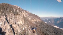 Paragliding flight by rocky mountain in forest nature landscape in early spring Adrenaline extreme adventure 
