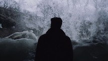 a man watching a waterfall 