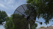 A vintage satellite dish changing position
