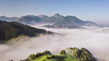Aerial view of foggy clouds in green mountains landscape Hyper lapse
