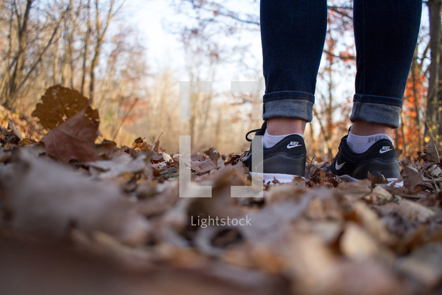 feet standing in fall leaves 