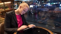 Time lapse shot of woman sitting in cafe using touch pad