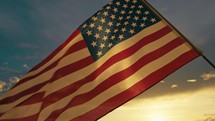 American flag waving at sunset.