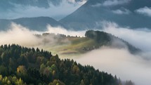 Wave of foggy clouds in forest country valley landscape time lapse 
