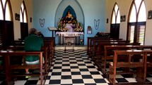 man praying alone in an empty church 