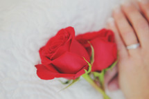 red roses and folded hands