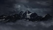 Dramatic mountain summit in Swiss Alps with clouds