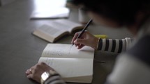 writing in a journal and reading a Bible 