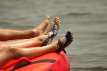 feet floating on an inner tube 