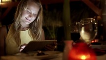 Woman using tablet PC in the restaurant on resort