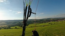 Paragliding Flying low above green meadow, Adrenaline fun
