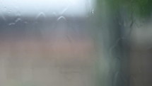 Sheets of rain sliding down a glass window pane