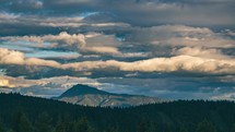Clouds time-lapse motion fast in beautiful nature mountains in summer sunset background sky