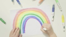 child drawing a rainbow 