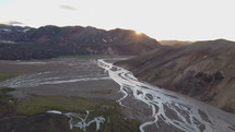 Aerial sunset over river delta in Iceland volcanic mountains
