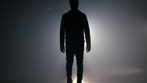 Silhouette of young man in leather jacket