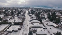 Aerial View Flying Over Snow-Covered Town