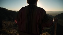 A Bible prophet standing on a mountain top at sunset