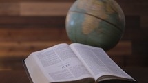 Vintage globe spinning with open Bible next to it. This footage is perfect for a missions focused video, a missions conference etc. 