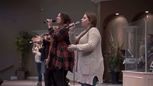 worship leaders singing and leading a congregation in song 