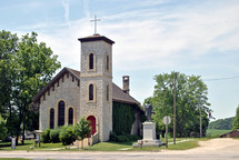 Small limestone country church shows beautiful architectural details in stonework and rafters.