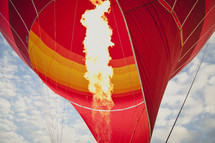 Fire blowing up inside of a hot air balloon