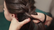 Braiding Woman's Long Hair - Three Strand Braid Style. - close up shot	