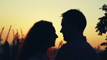 Young couple of man and woman at sunset