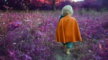 Two little toddler boys cosplay gnomes or hobbits in long capes walking barefoot in wonderland purple pink forest. Halloween, kids concept. Amazing fairy tale character. quality FullHD footage