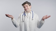 Confused 30s aged physician in white medical coat form, shoulders up - can't help, makes gesture of I dont know. Difficult question, guilty reaction, puzzled man on studio background. High quality 4k