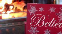 Christmas card in front of a fire in a fireplace 