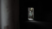a woman walking into a dark room 