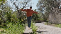 Calabrian Country Boy Walks On A Wall During Sunny Day