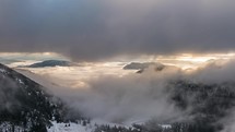 Mystic Winter mountains hidden in misty clouds in beautiful nature landscape time-lapse
