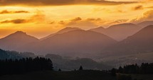 Golden clouds sky moving fast over autumn mountains landscape at sunset timelapse
