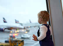 Kid near the window in the airport