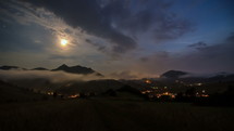Moonlight night with fast moving clouds over rural country Time lapse
