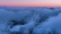 Peaceful time lapse of blue misty clouds before sunrise.