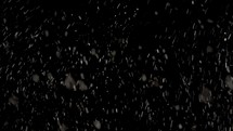 Snow falling over black background.