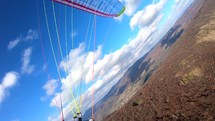 Paragliding fly high above mountains in sunny nature, freedom adrenaline adventure
