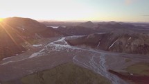 Aerial sunset over river delta in Icelandic mountains
