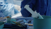 Close up on hands and instruments as Surgeons work during open heart surgery.