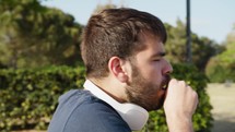 Boy Coughs From Allergy Outdoors In A Public Park In Spring