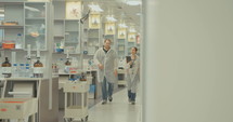 Scientists walking in halls of a pharmaceutical lab