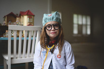 a child playing dress up as a doctor 