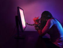 woman chained to her computer 