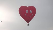 parachuters and heart shaped hot air balloons 