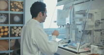 Lab technician working in a pharmaceutical laboratory conducting experiments