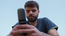 Young Man Sends Messages On A Vintage Button Telephone